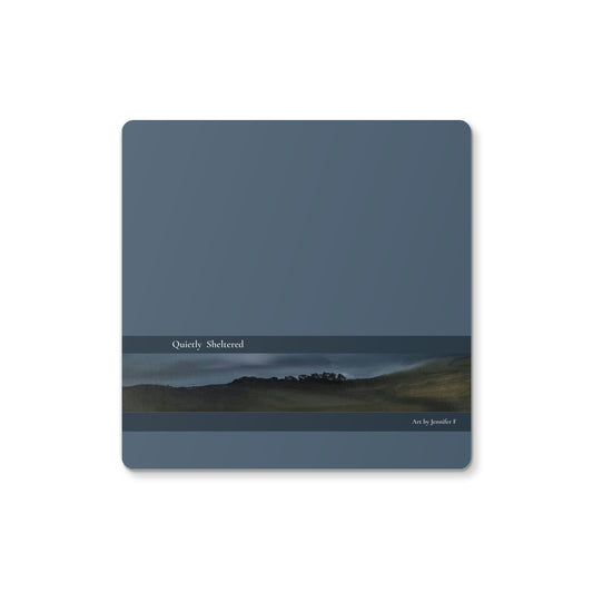 Quietly Sheltered art coaster by Jennifer F, featuring a lake landscape with distant trees, muted blue-grey sky and darker land along the water.
