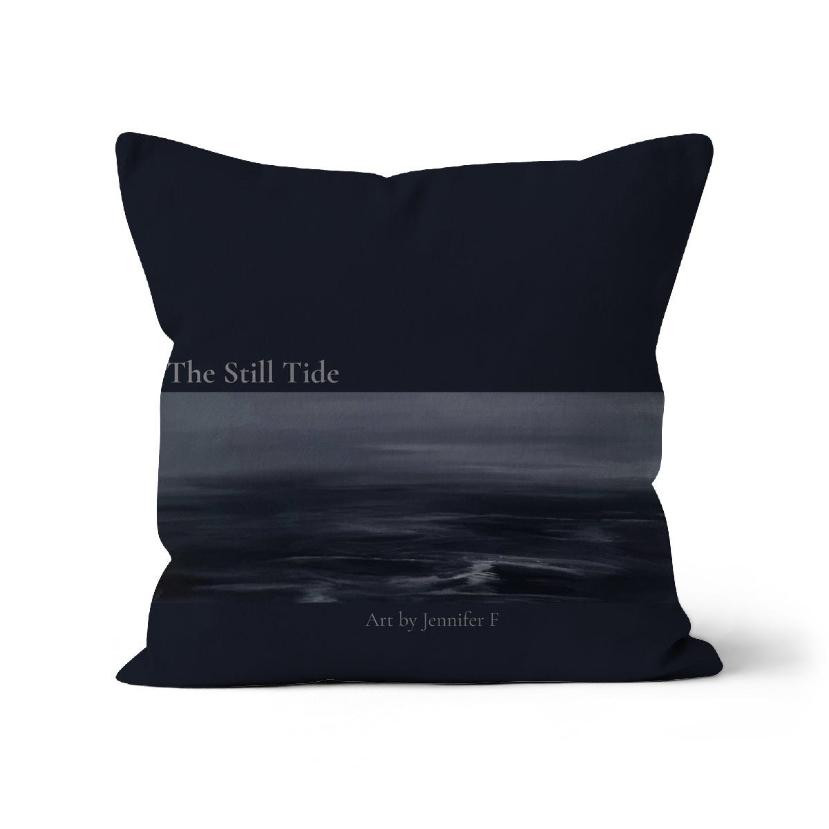 The Still Tide art cushion by Jennifer F, featuring a deep navy background with a horizontal section of misty seascape artwork in grey-blue tones.